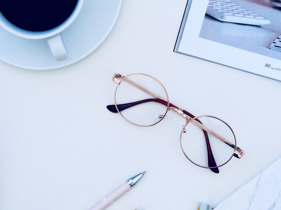 Round luxury prescription eyeglasses on a desk