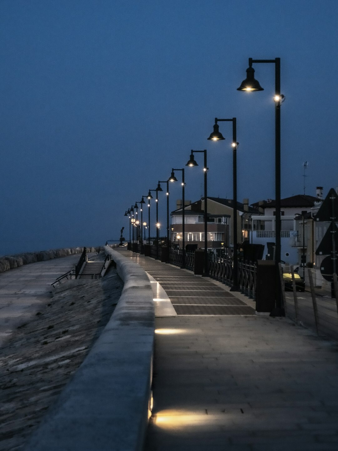 Elegant seaside promenade at dusk with warm lights
