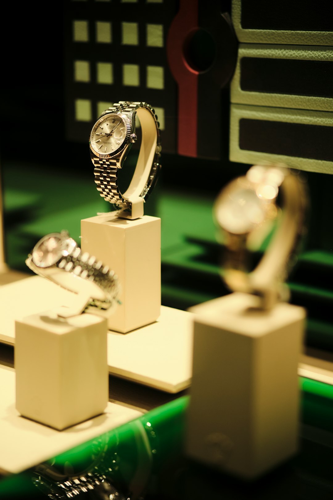 Well-dressed man examining a luxury watch in a boutique