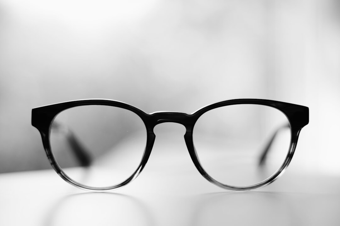 Designer acetate eyeglasses on a neutral surface