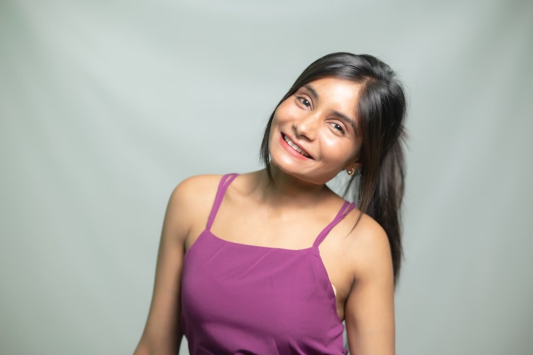 Studio portrait of a young professional hispanic woman smiling softly