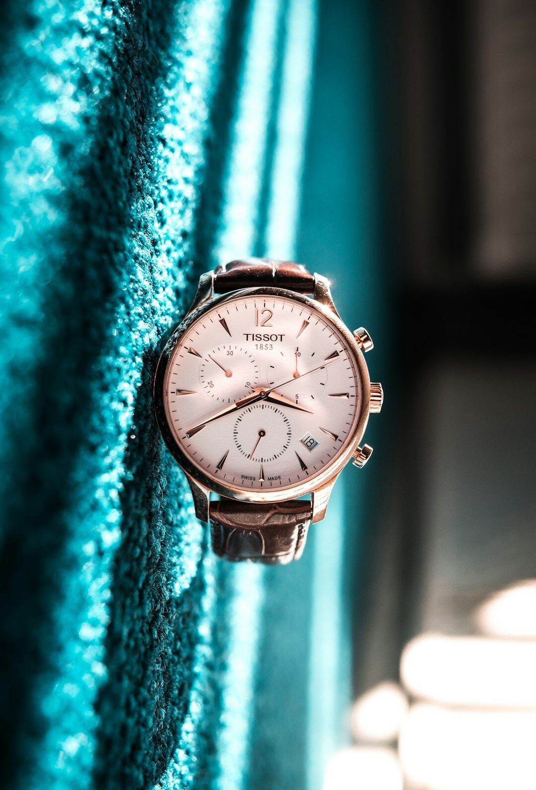 Minimalist leather strap dress watch on wood surface